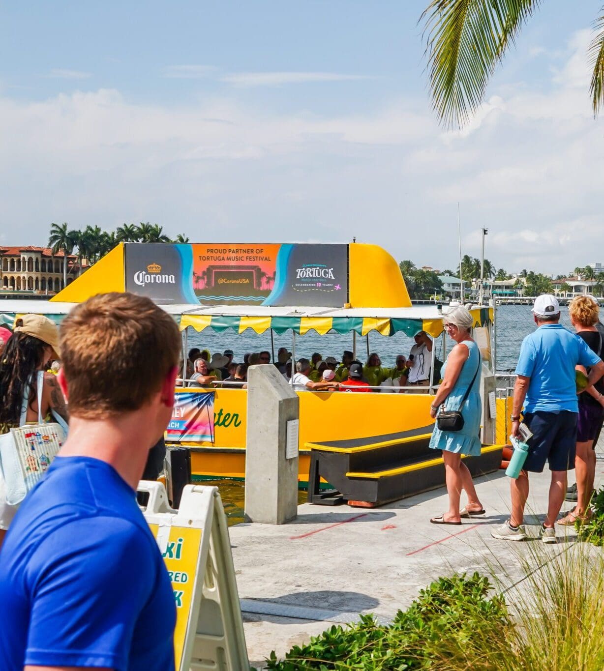 Man staring at billboard boat with corona advertisement