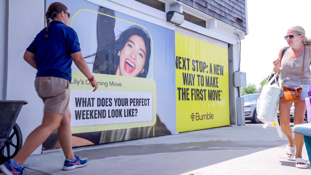 A wallscape with a girl promoting a Bumble message