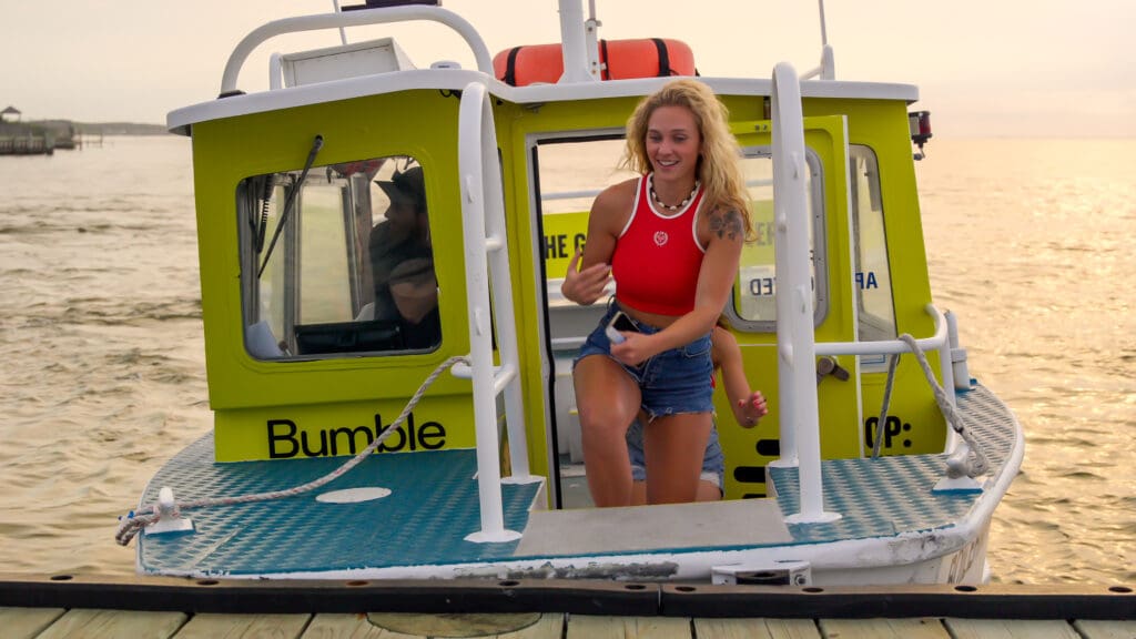 Woman in red stepping off a fire island water taxi