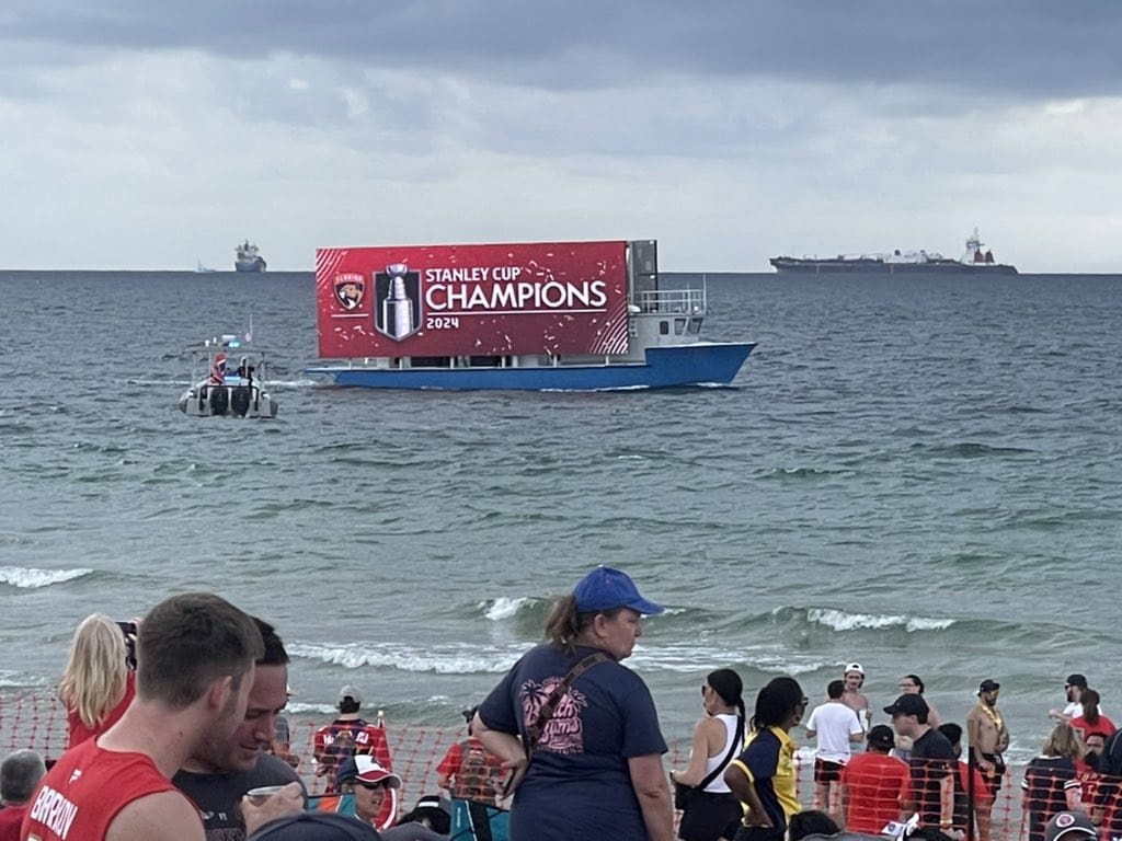 A floating billboard boat displaying Florida Panthers Championship advertisement in Fort Lauderdale Beach during the Florida Panthers Parade Celebration