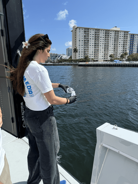 Girl on a digital billboard boat and bay in the background