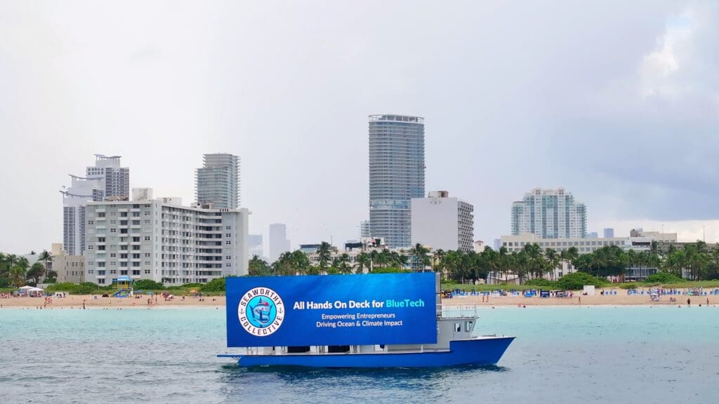 Digital billboard boat in Miami displaying a Seaworthy Collective advertisement focusing on sustainable blue tech solutions