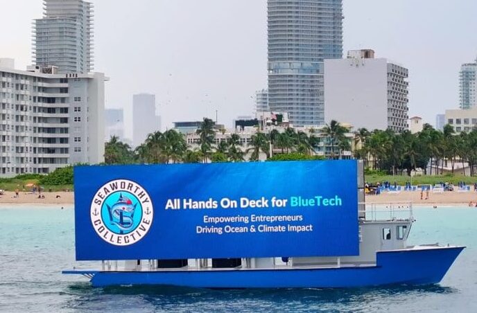 Digital billboard boat in Miami displaying a Seaworthy Collective advertisement focusing on sustainable blue tech solutions